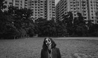 A Bangladeshi cosplayer in a Joker costume 