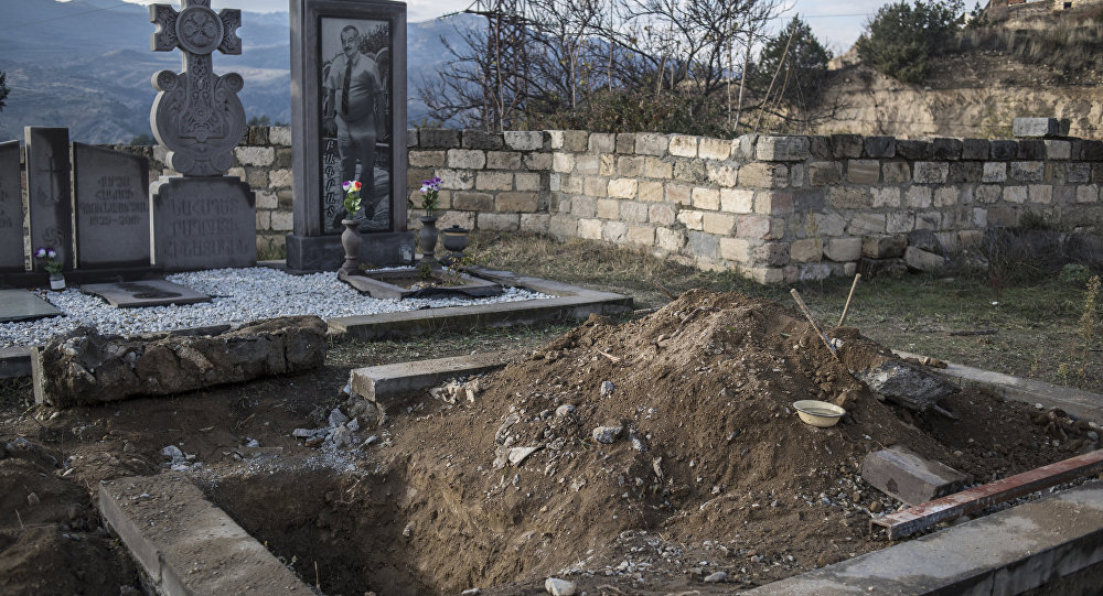 A grave in a cemetery in Lachin, Nagorno-Karabakh. Some residents exhumed the remains of relatives and took them to rebury in Armenia, when they left their homes in Nagorno-Karabakh following the November peace agreement.