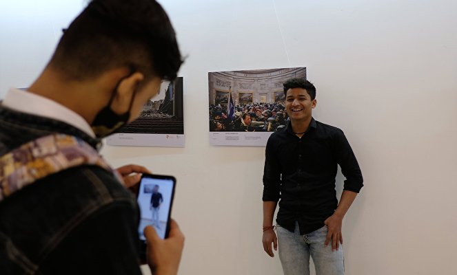 Visitors attend the Stenin Photo Contest exhibition opening ceremony, in New Delhi, India. 
