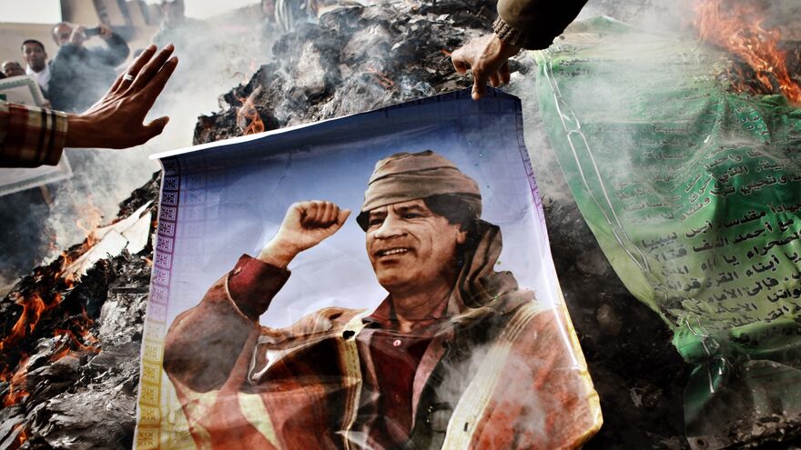 Benghazi residents burn portraits of Muammar Gaddafi, banners with his quotes and his Green Book.