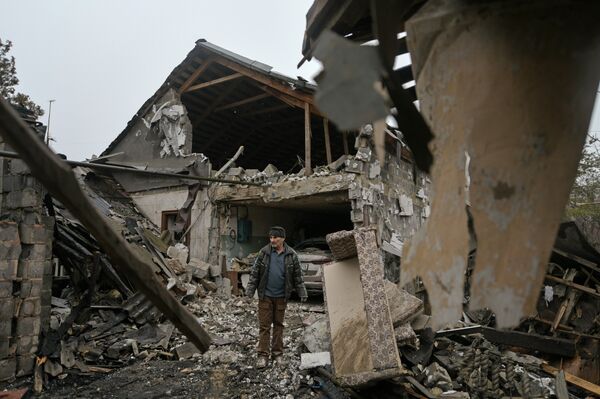 A man outside his destroyed house